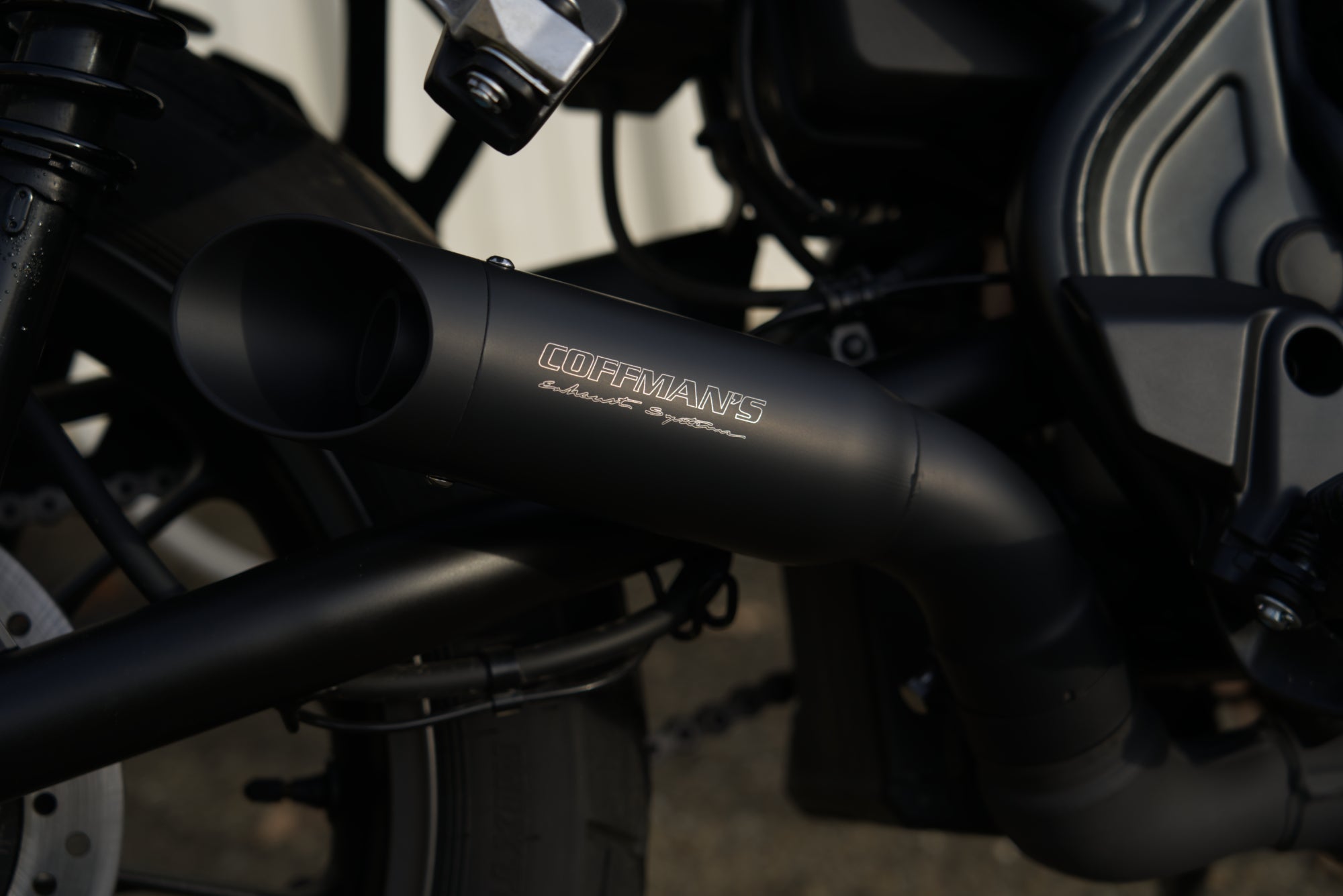 Coffman exhaust nameplate on Honda SCL500 muffler